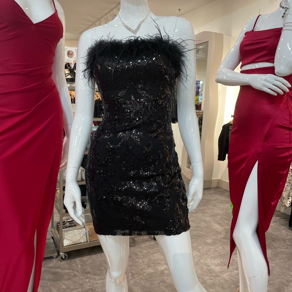 Black strapless dress with feathers around the top